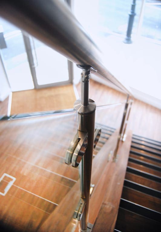 close up of a brushed stainless steel and glass balustrade in a straight staircase