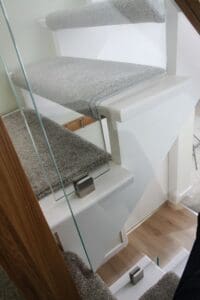 Shaped Glass with square steel clamps
