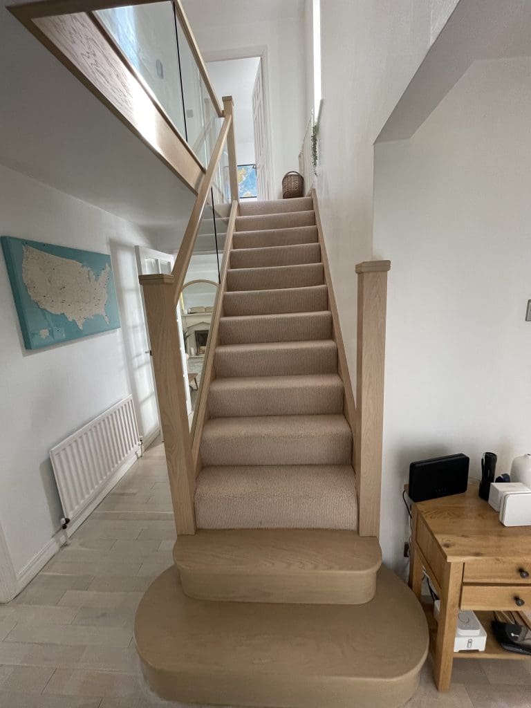 A stained urban oak staircase with 10mm embedded glass installed in Gateshead, Tyne & Wear