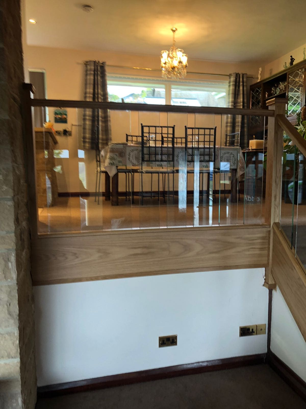 A staircase renovation in the Peak District with glass spindles and oak rails.