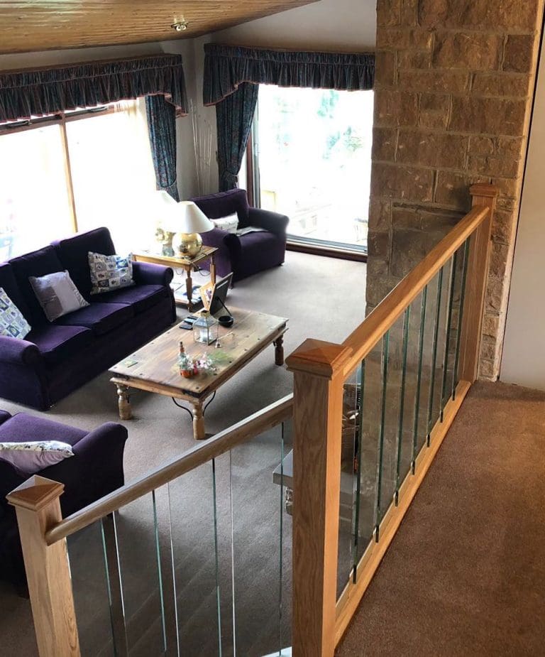 A staircase renovation in the Peak District with glass spindles and oak rails.