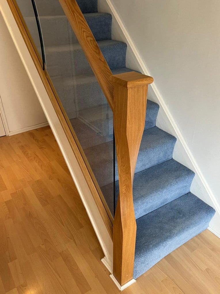 shaped glass panels and twisted newel posts in an Abbott-Wade staircase renovation in Solihull