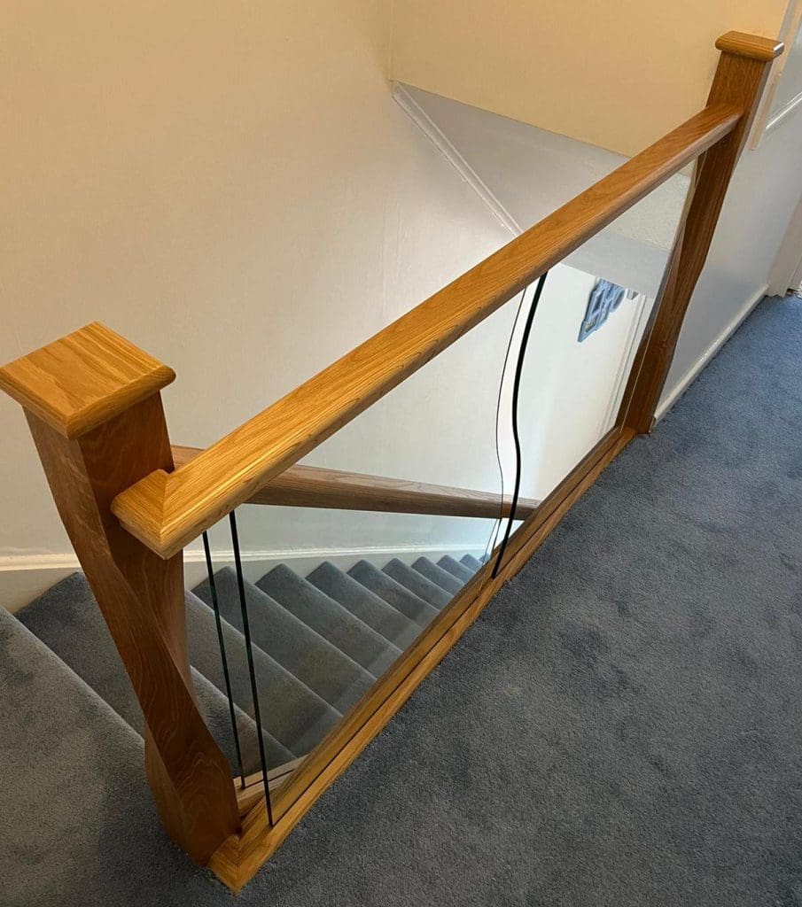 shaped glass panels and twisted newel posts in an Abbott-Wade staircase renovation in Solihull