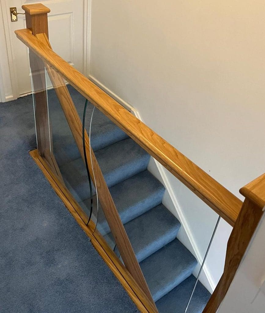 shaped glass panels and twisted newel posts in an Abbott-Wade staircase renovation in Solihull