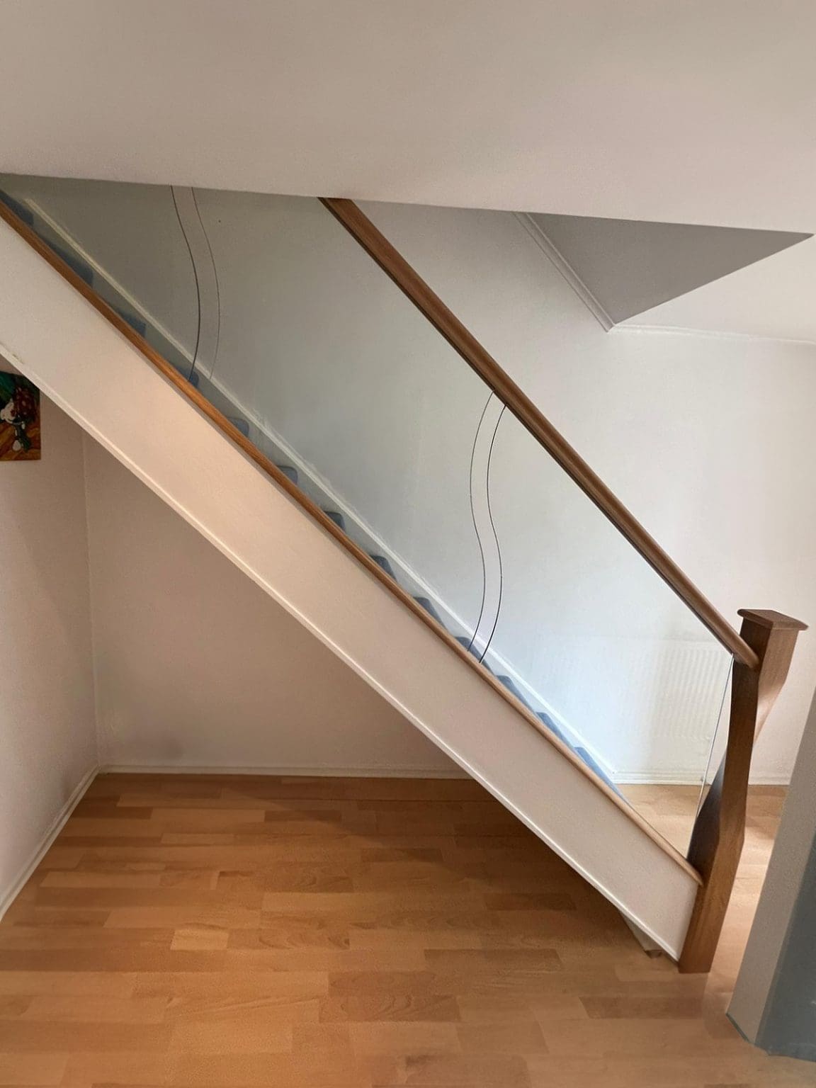 shaped glass panels and twisted newel posts in an Abbott-Wade staircase renovation in Solihull