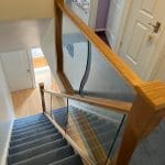 shaped glass panels and twisted newel posts in an Abbott-Wade staircase renovation in Solihull