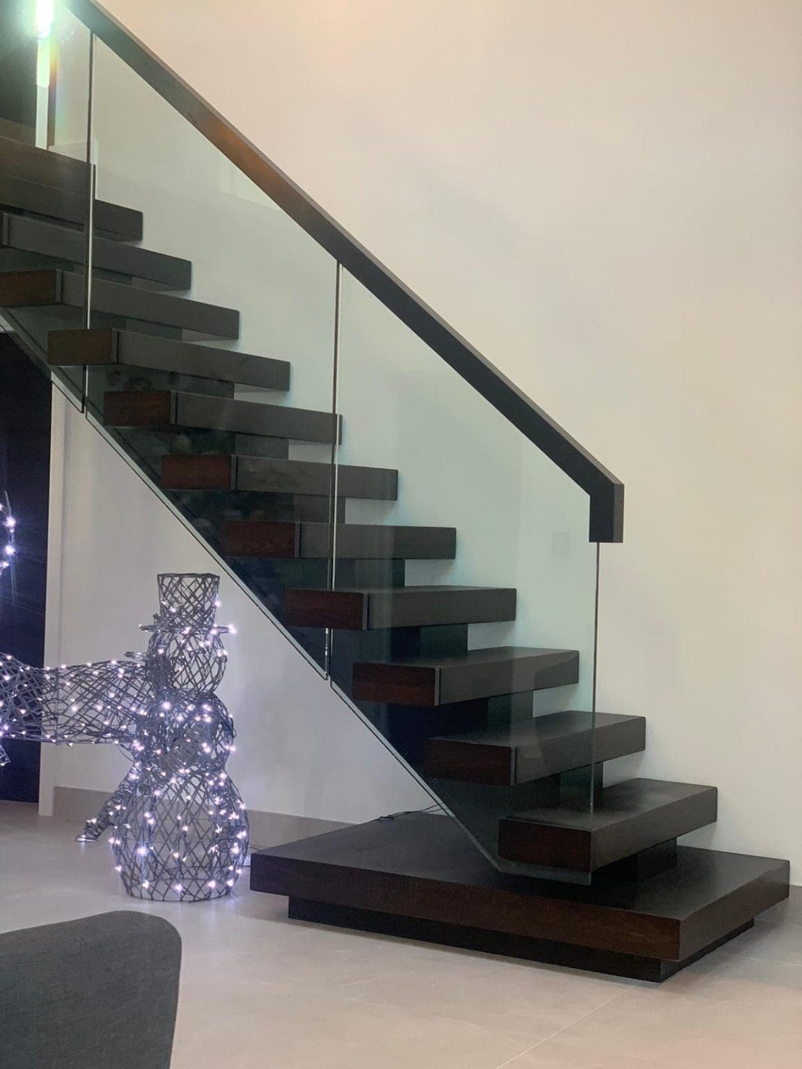 A luxury mono-string frameless glass staircase staircase with stained ok installed in the Lake District