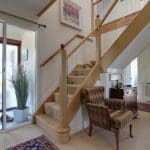 an oak and glass staircase renovation in Kilmarnock with traditional ball caps