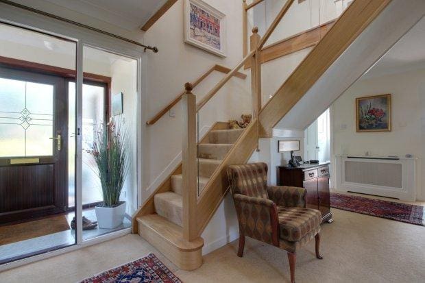 an oak and glass staircase renovation in Kilmarnock with traditional ball caps