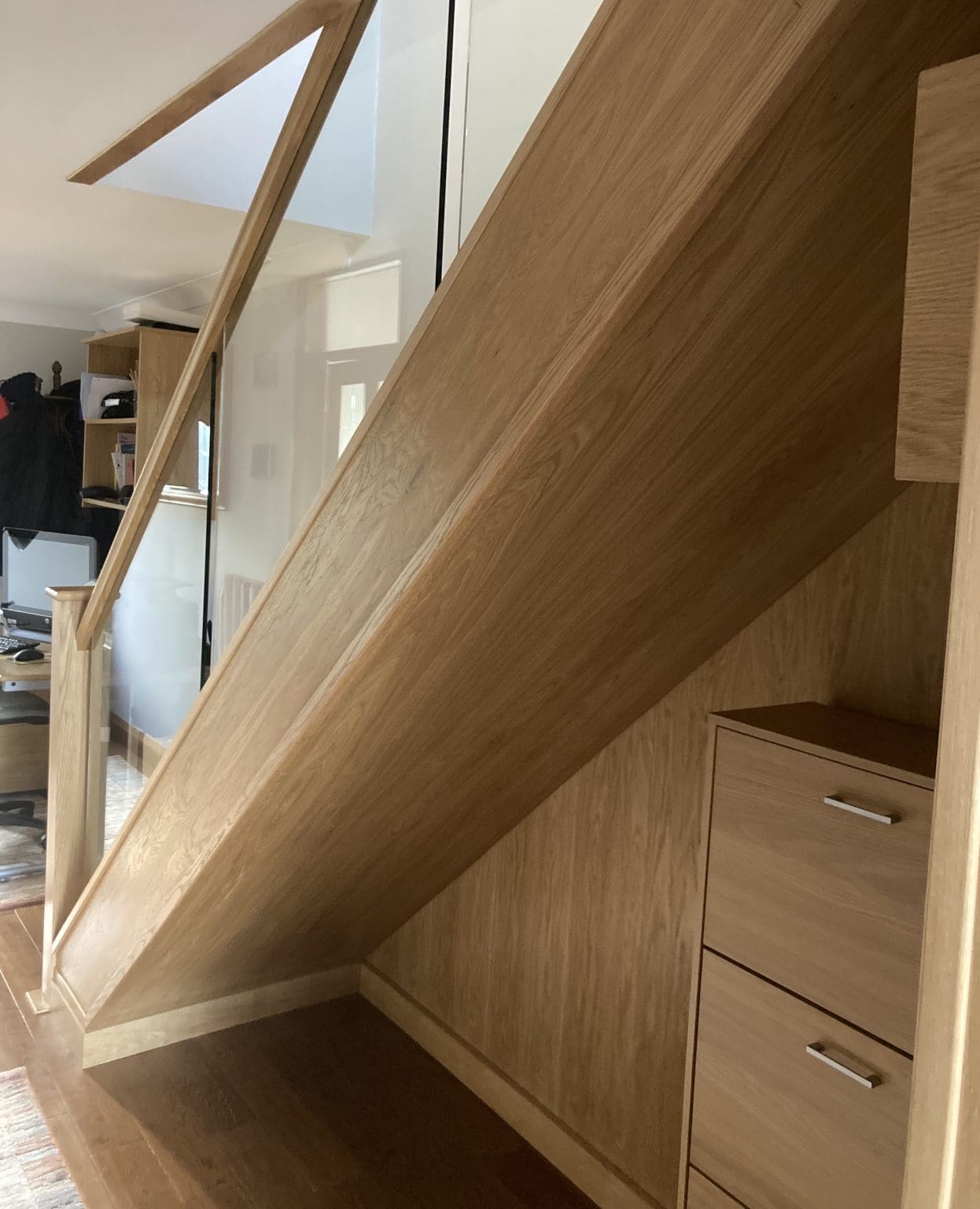 The before & after photos of this Castleford staircase show the added cohesion this oak & glass staircase renovation provides with its existing surroundings.