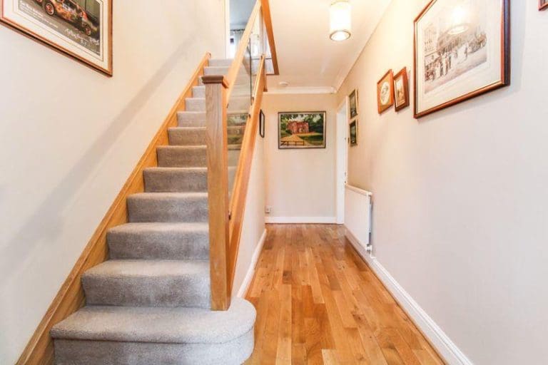 A warming oak & glass staircase renovation in Leek breathes new life into this Staffordshire hallway.