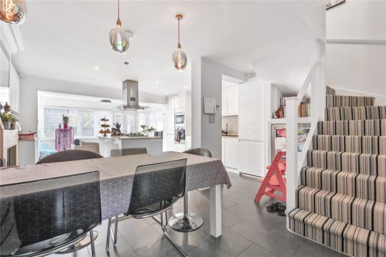 A modern bright white staircase renovation with embedded glass in Richmond upon Thames