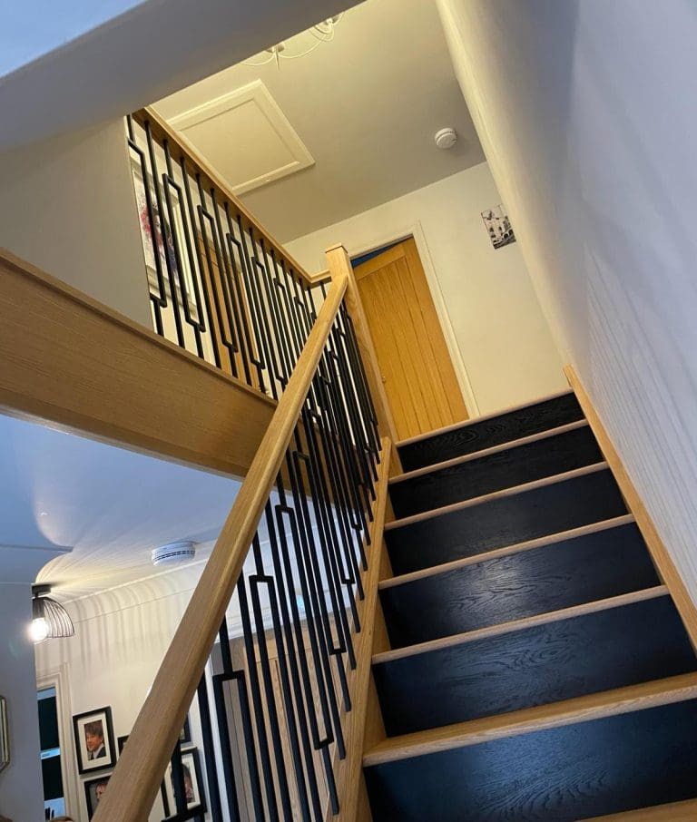 A striking 2-tone oak & black staircase renovation in Beverley with Abbott-Wade's cutting edge Frame spindles.