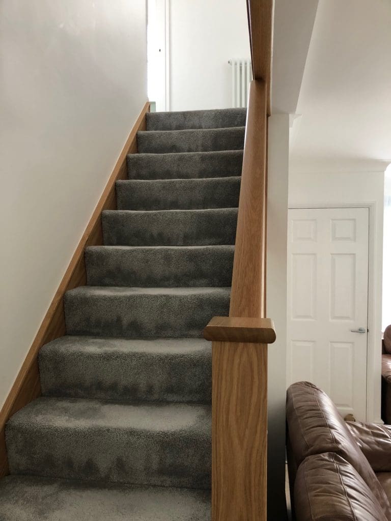 A diminishing Essex staircase renovation uses oak & 10mm embedded glass to transform this living area in Billericay.