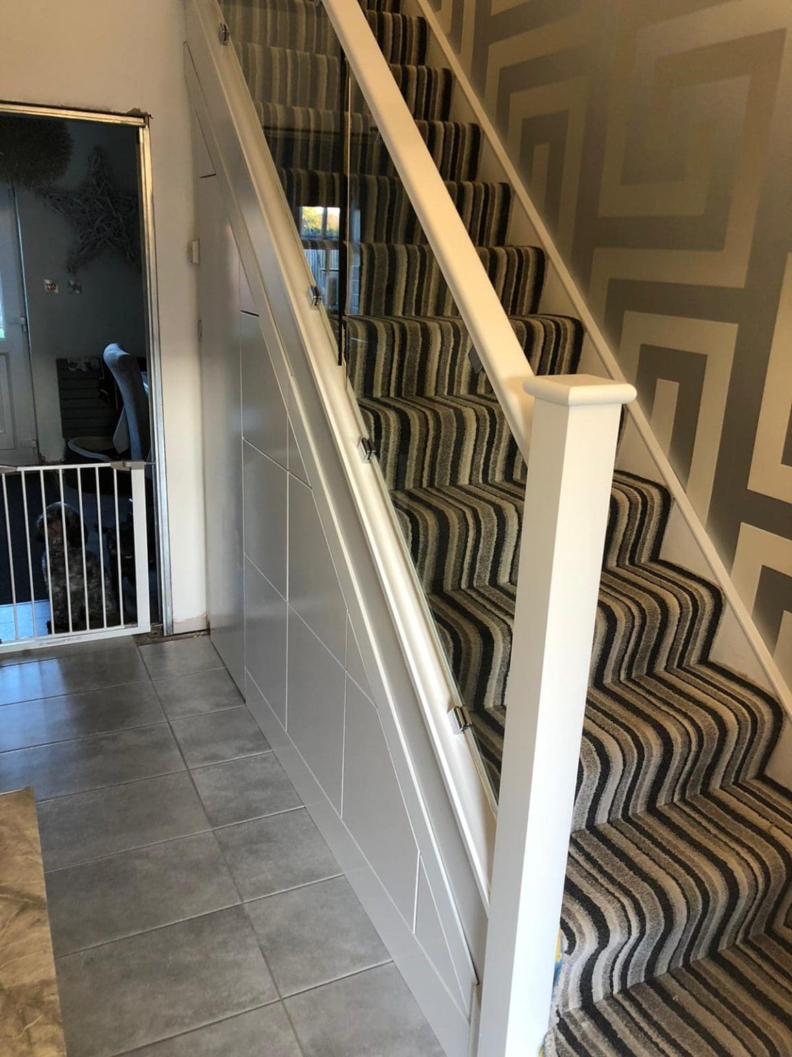 A white staircase renovation in Cheadle, Staffordshire with 10mm clamped glass panels