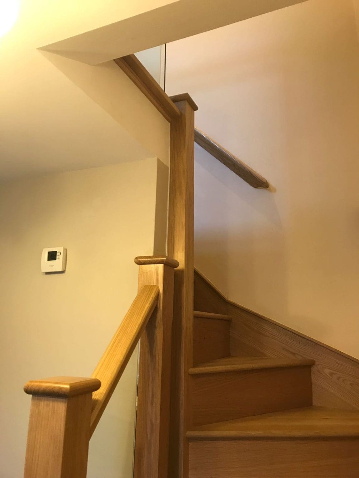 New oak treads and risers paired with oak newels and glass panels create a striking finish in this Eastleigh home.