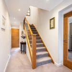 This Bryn staircase refurb pairs beautifully with the internal oak doors & combining glass with mirrored surfaces accentuates the feeling of space & light.