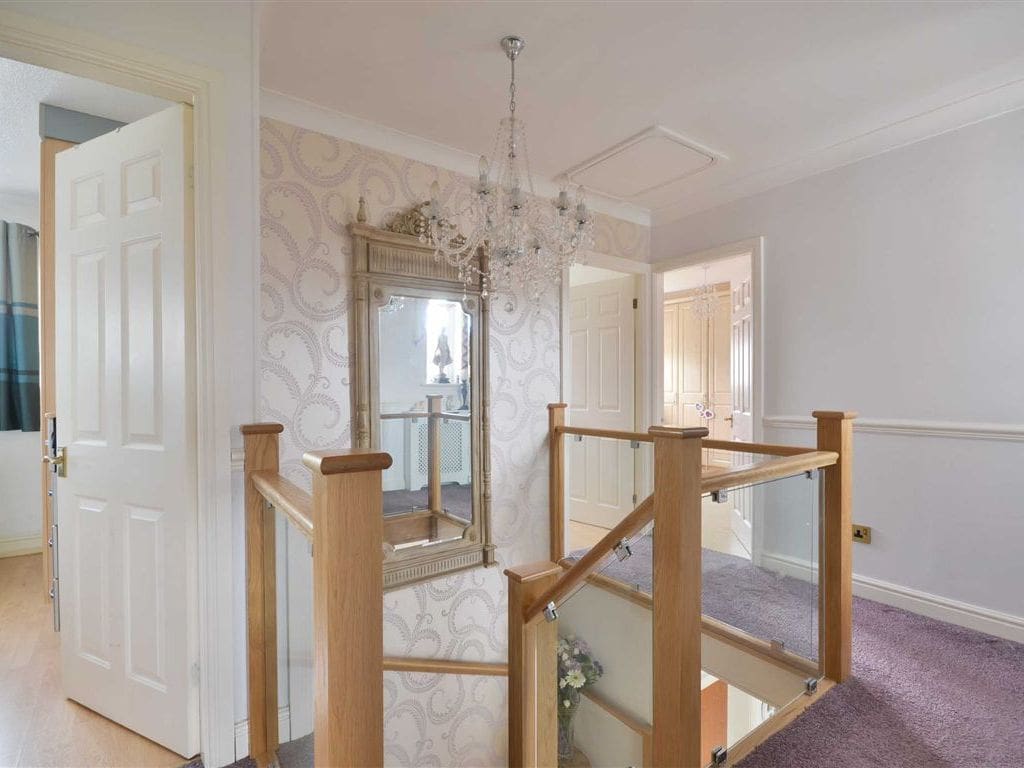 This winding clamped glass in Hindley has the added flourish of a double curtail feature step.