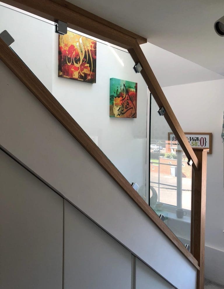 A diminishing glass staircase renovation in Wokingham including an oversized glass partition