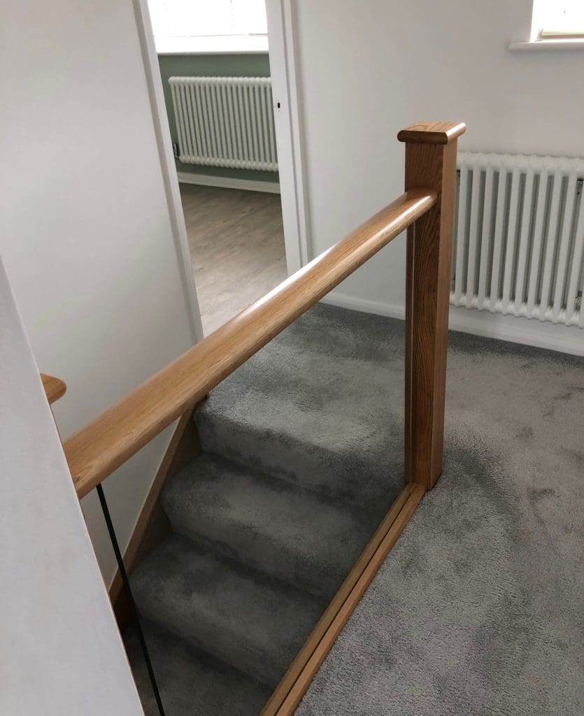 A diminishing Essex staircase renovation uses oak & 10mm embedded glass to transform this living area in Billericay.