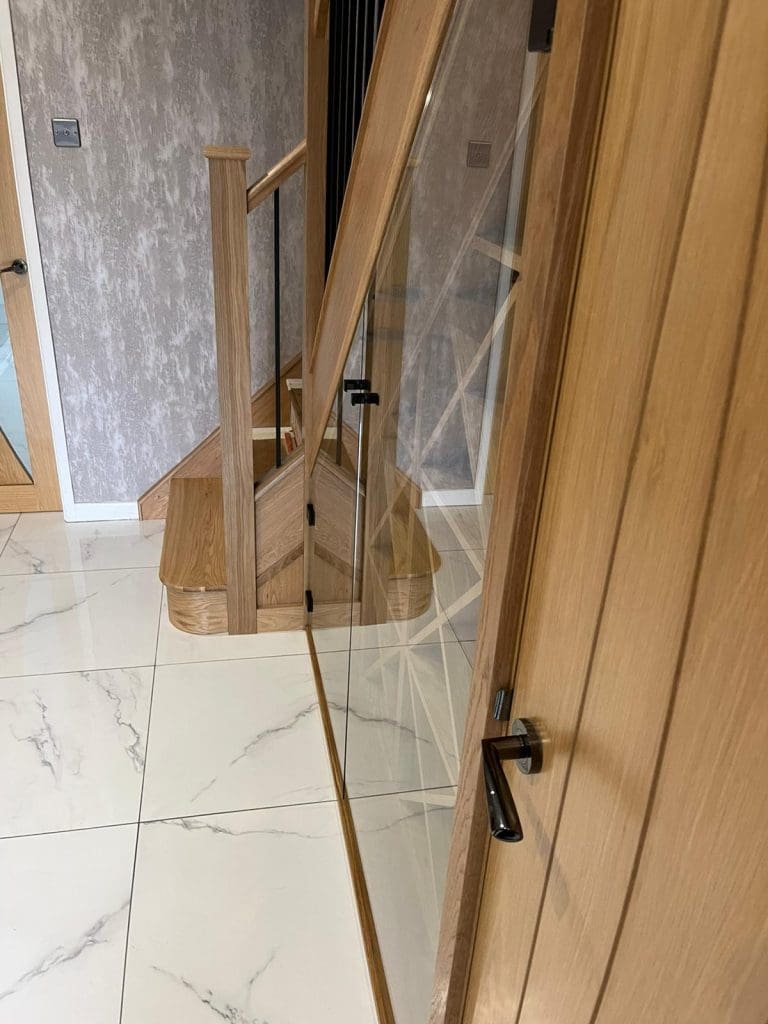 The stunning understairs wine rack housed behind glass is a stunning centrepiece to this Wigan home, framed against a truly beautiful staircase in Billinge, Wigan.