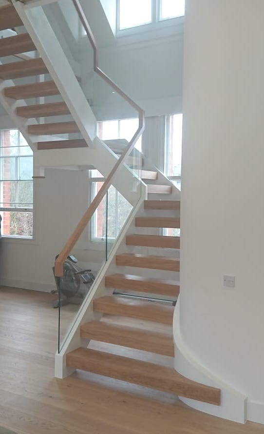 Carefully crafted to fit into a tight former industrial space, this super modern frameless glass staircase is perfectly engineered for its' repurposed home.