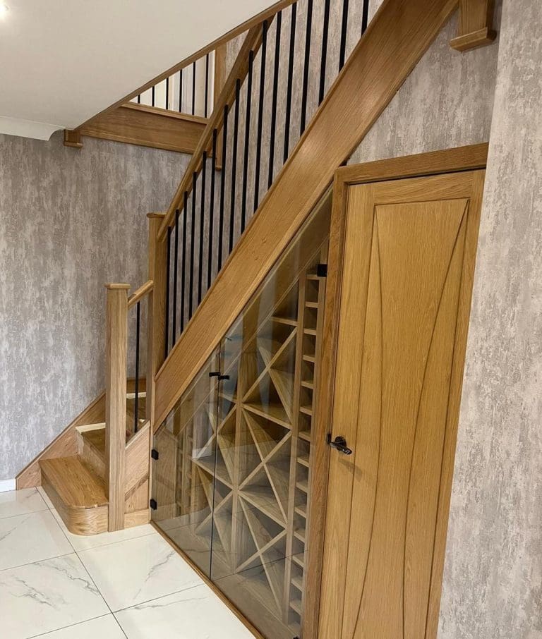 The stunning understairs wine rack housed behind glass is a stunning centrepiece to this Wigan home, framed against a truly beautiful staircase in Billinge, Wigan.