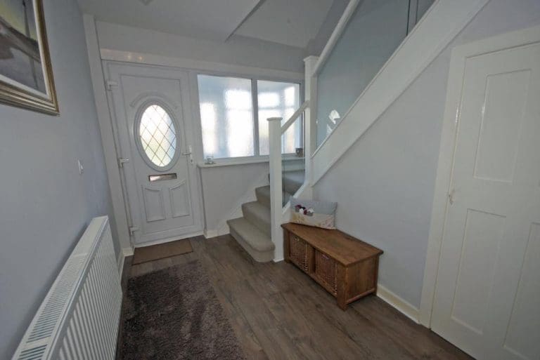 A full white & embedded glass Abbott-Wade staircase renovation brightens up this Crosby home.