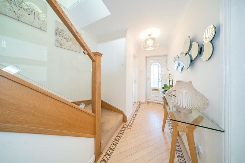 A bright hallway in Eccleston. St Helens elevated with an oak & glass Abbott-Wade staircase renovation.
