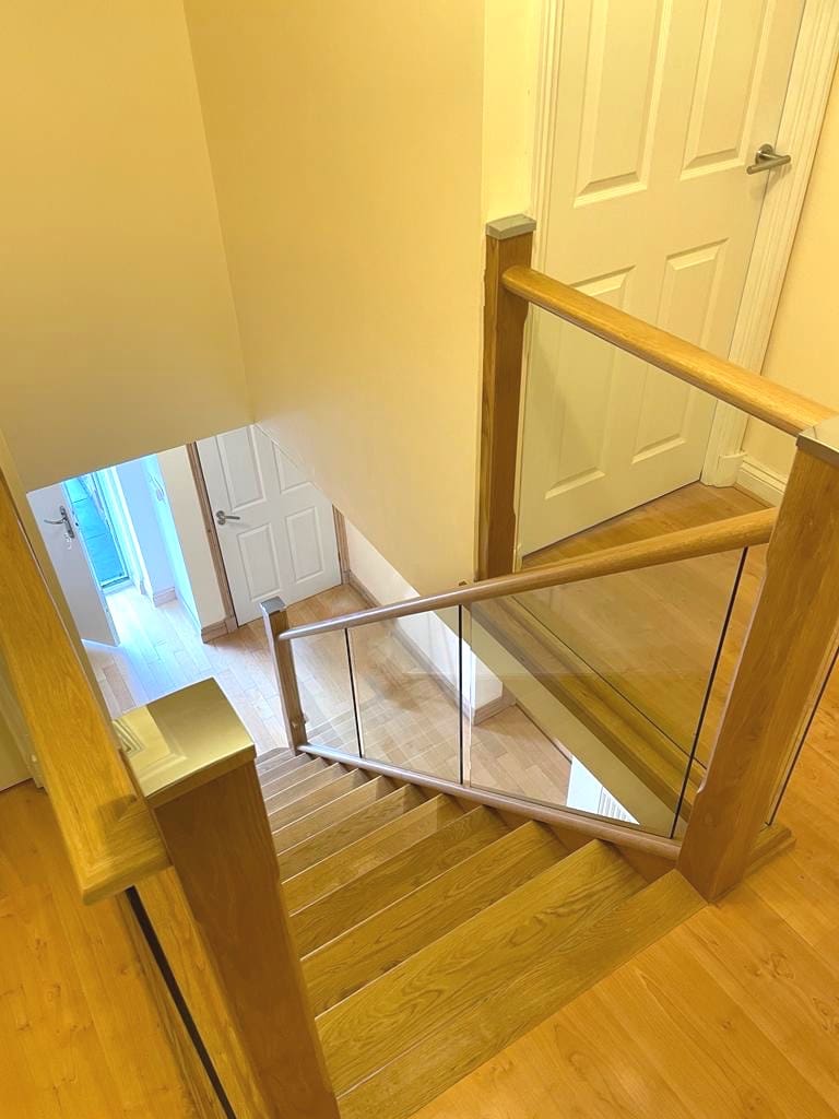 A Penrith home transformed with an oak & glass staircase renovation with fully clad treads & risers