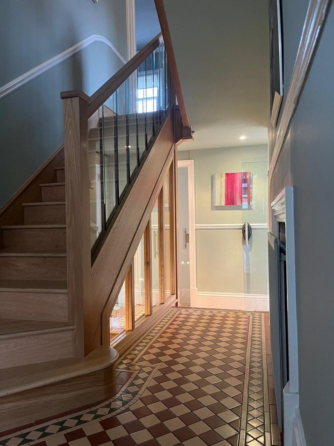Stunning full height glass panels separate the upper & lower staircases to create a dramatic, eye-catching Stevenage staircase & hallway.