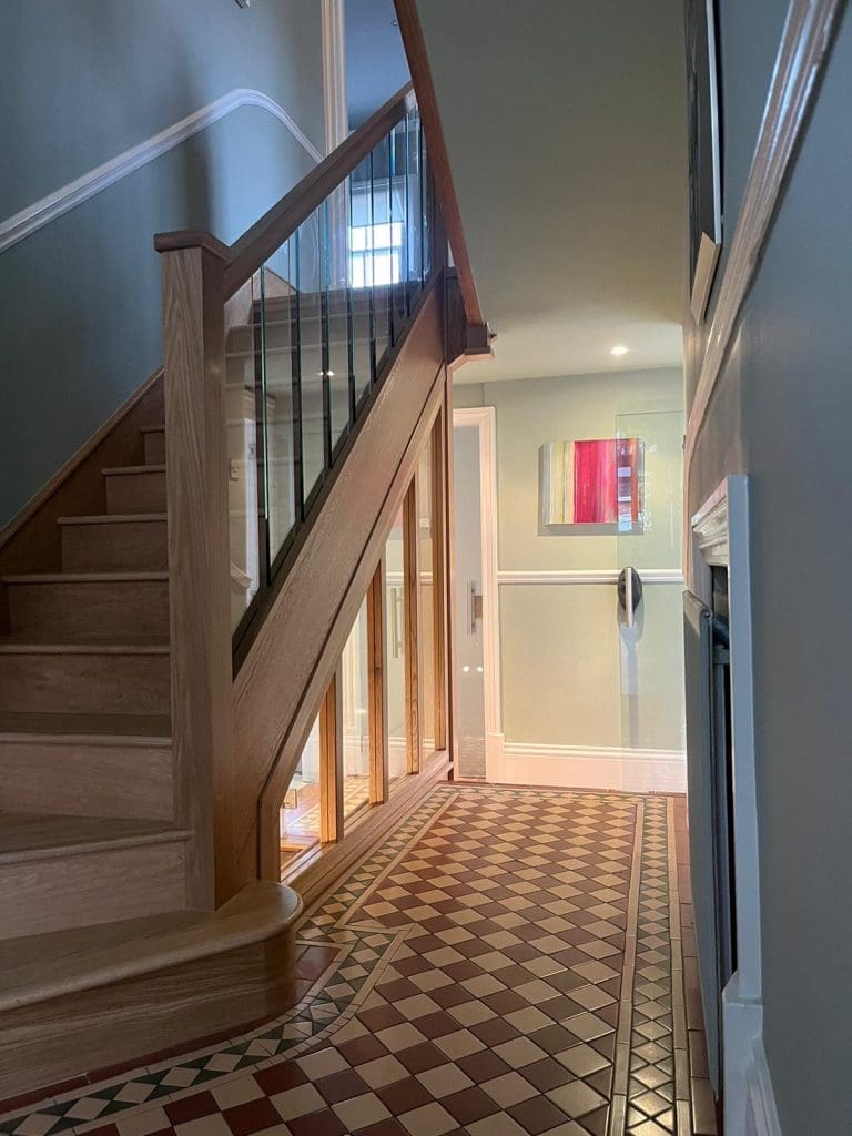 Stunning full height glass panels separate the upper & lower staircases to create a dramatic, eye-catching Stevenage staircase & hallway.