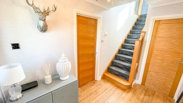 This doesn’t fee like a staircase between walls. The clever first first feature step and newel post add an element of grandeur to this Newton hallway that wasn't there before!