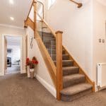 A stylish oak & embedded glass staircases pairs beautifully with existing oak doors & fixtures in this Disley home.