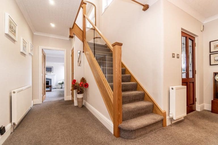 A stylish oak & embedded glass staircases pairs beautifully with existing oak doors & fixtures in this Disley home.
