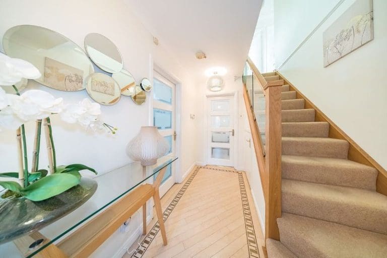 A bright hallway in Eccleston. St Helens elevated with an oak & glass Abbott-Wade staircase renovation.