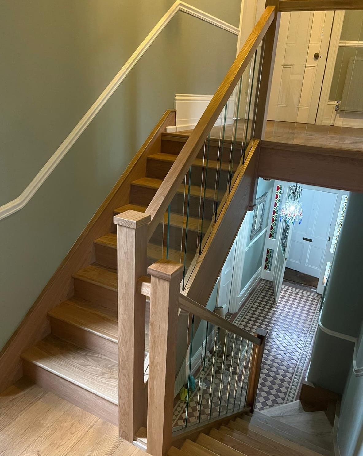 Stunning full height glass panels separate the upper & lower staircases to create a dramatic, eye-catching Stevenage staircase & hallway.