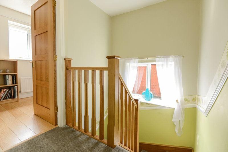 A timeless stop chamfered oak staircase in Shevington with an eye catching oak feature first step.