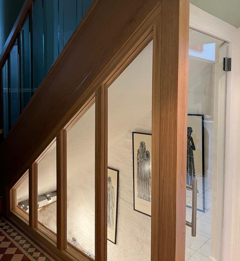Stunning full height glass panels separate the upper & lower staircases to create a dramatic, eye-catching Stevenage staircase & hallway.