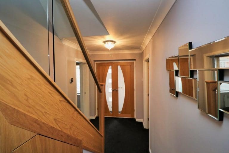 This hallway in Lowton is warmed and brightened thanks to an Abbott-Wade staircase refurbishment