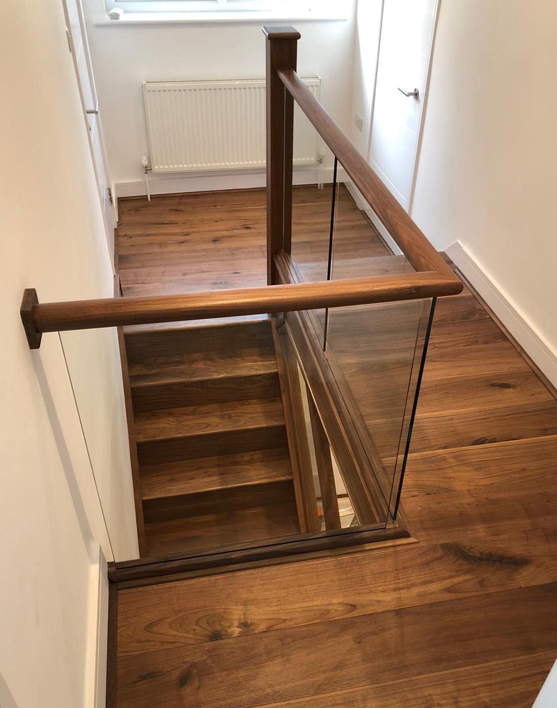 The beautiful & rich tones of natural walnut ensure every step of this Regents Park staircase renovation feels luxurious.