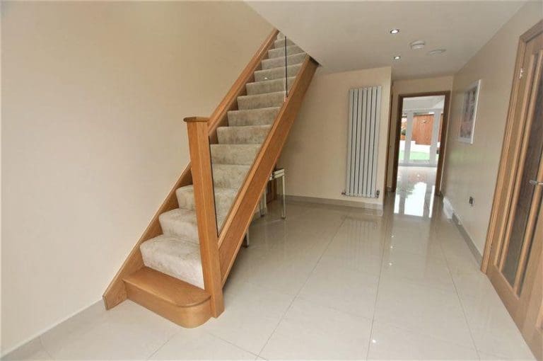 A new straight oak & glass staircase which is striking in its simplicity, transforming this large entrance hall in Farnworth.
