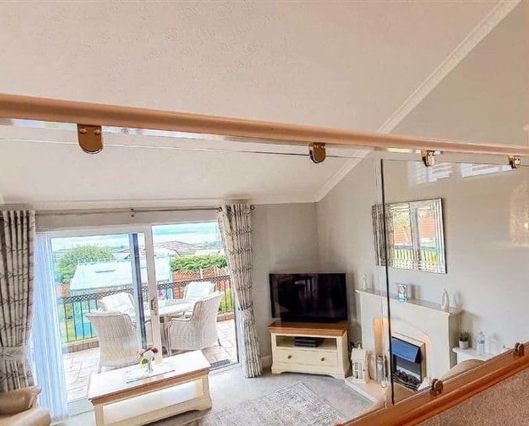 A split-level living home united thanks to an oak & glass balustrade in Flint, Flintshire.
