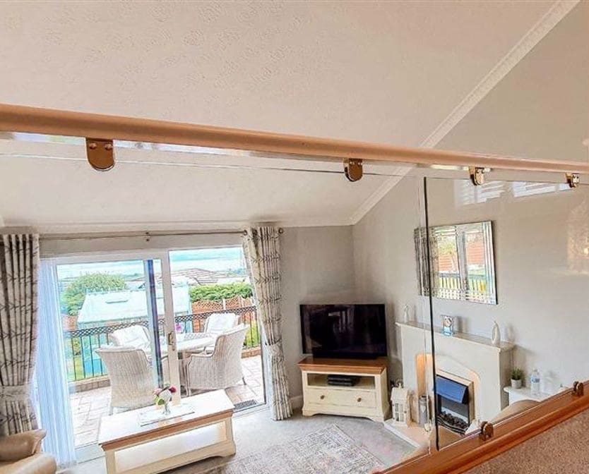 A split-level living home united thanks to an oak & glass balustrade in Flint, Flintshire.