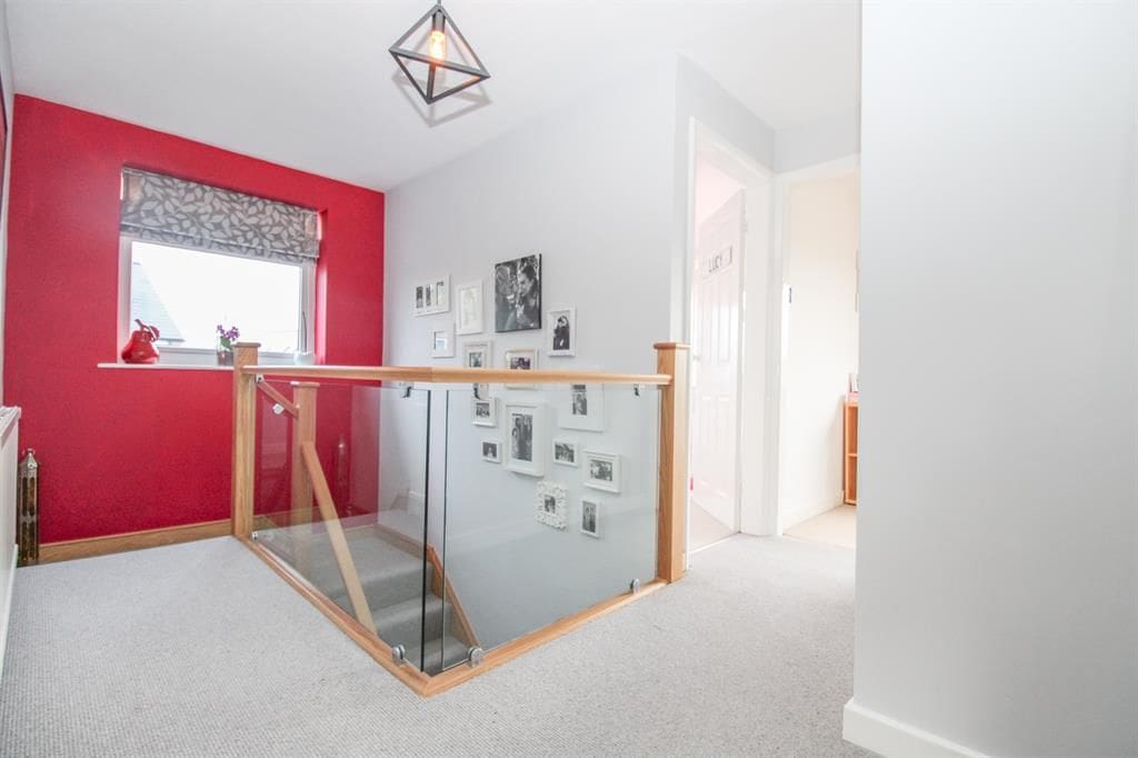 Light floods this Horsforth home's hallyway thanks to our 10mm clamped glass balustrade.