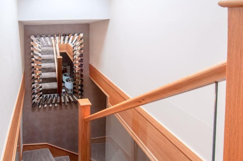 A winding prefinished natural oak & glass staircase renovation in Rushden.