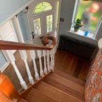 An elegant combination of natural sapele & contrasting white turned spindles in Woolston complete with an elegant volute.