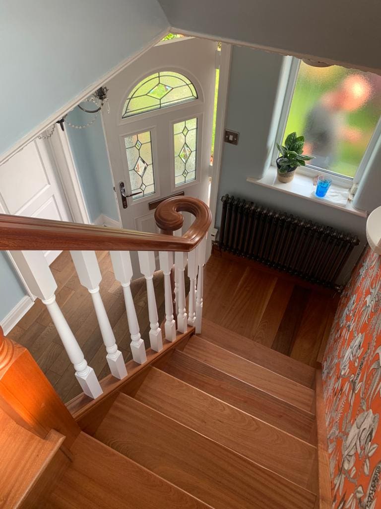 An elegant combination of natural sapele & contrasting white turned spindles in Woolston complete with an elegant volute.