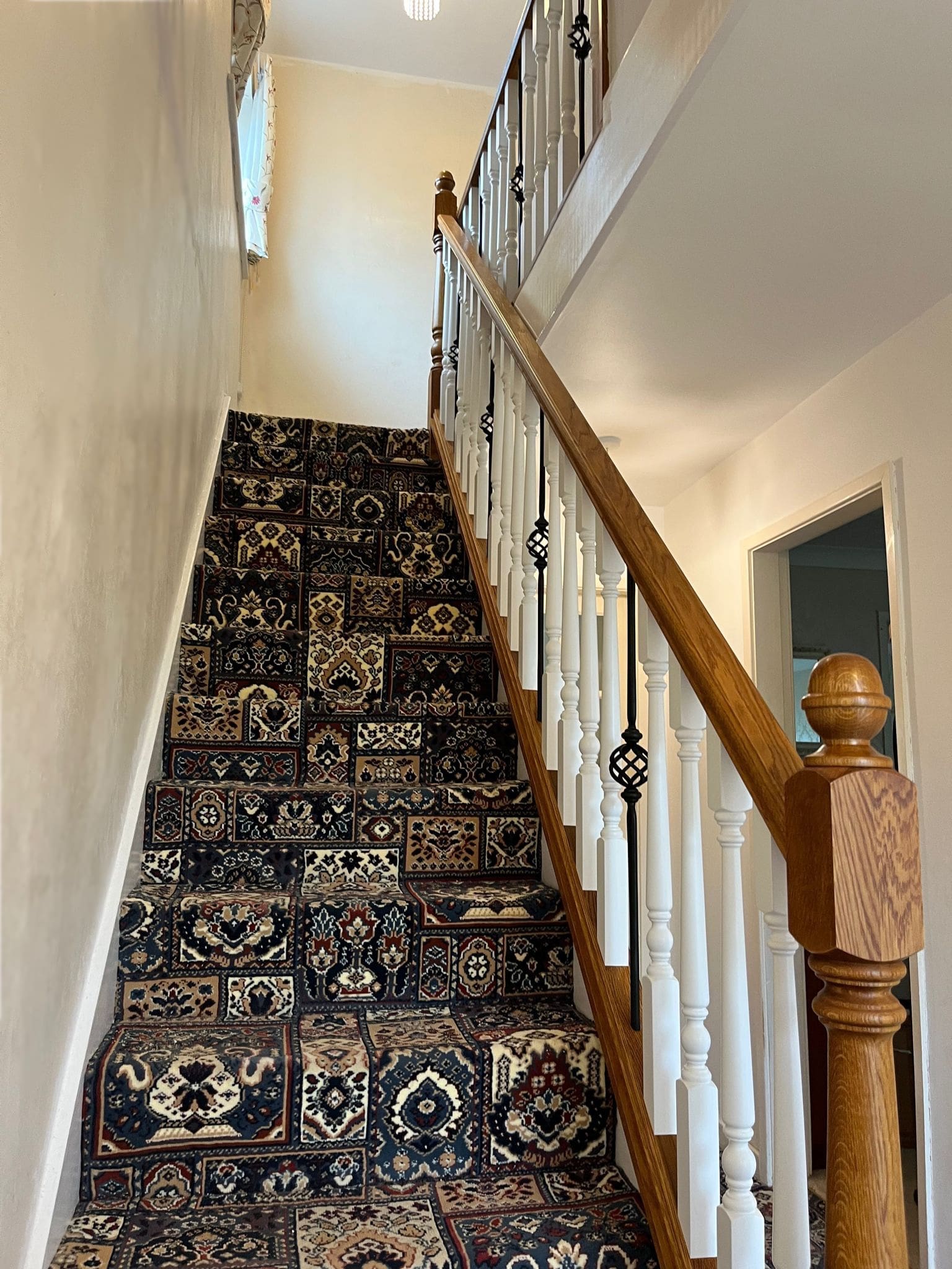 A traditionally styled stained oak staircase in Neston combine wooden spindles with forged steel in this Wirral home.