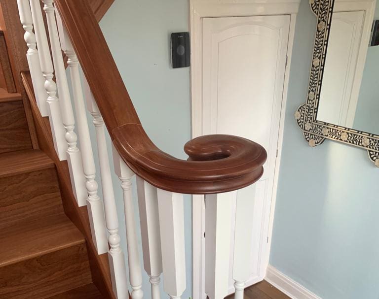 An elegant combination of natural sapele & contrasting white turned spindles in Woolston complete with an elegant volute.